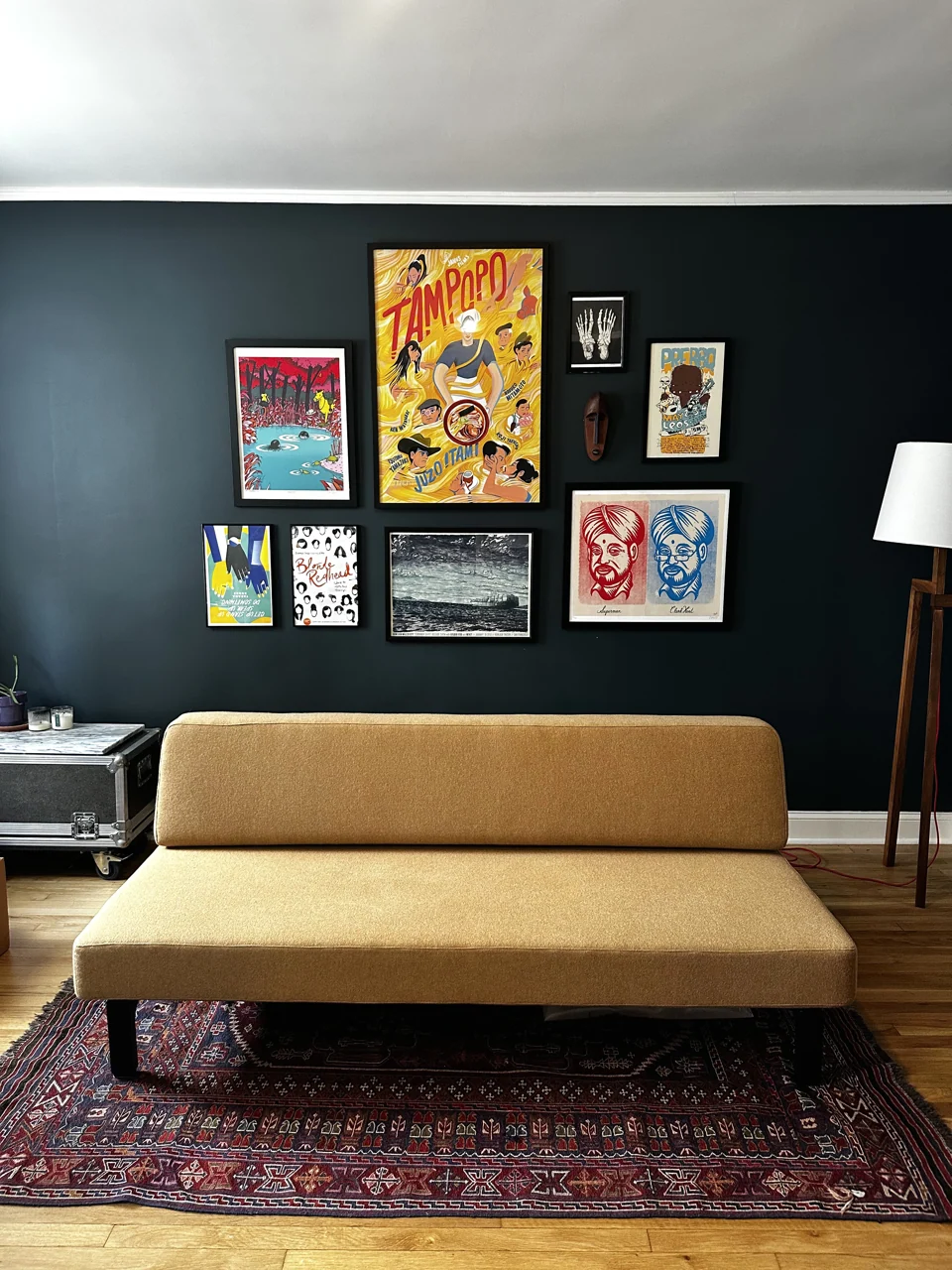 Colorful gallery wall above a yellow sofa