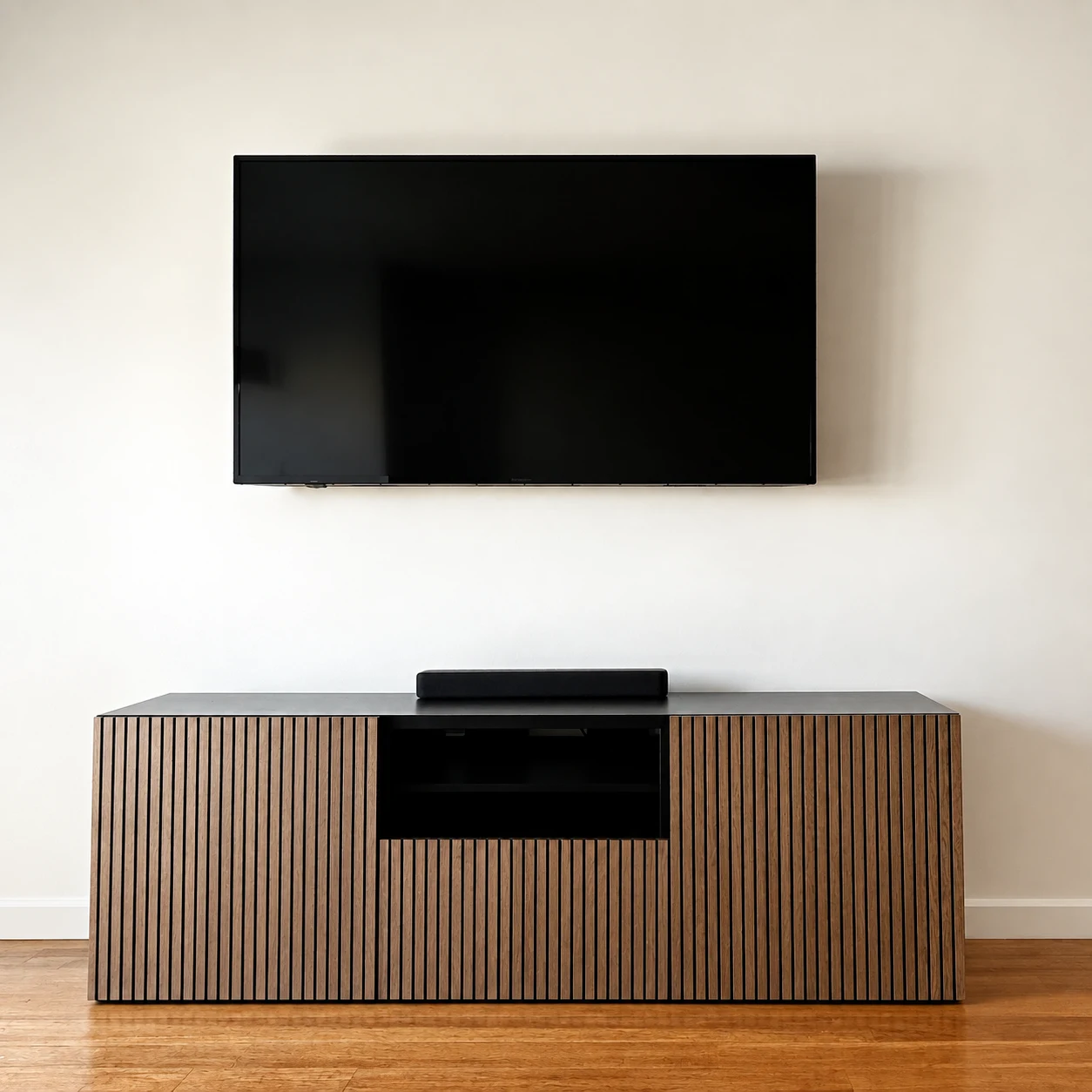 Wall-mounted TV, slatted wood media console and soundbar; room clutter digitally removed