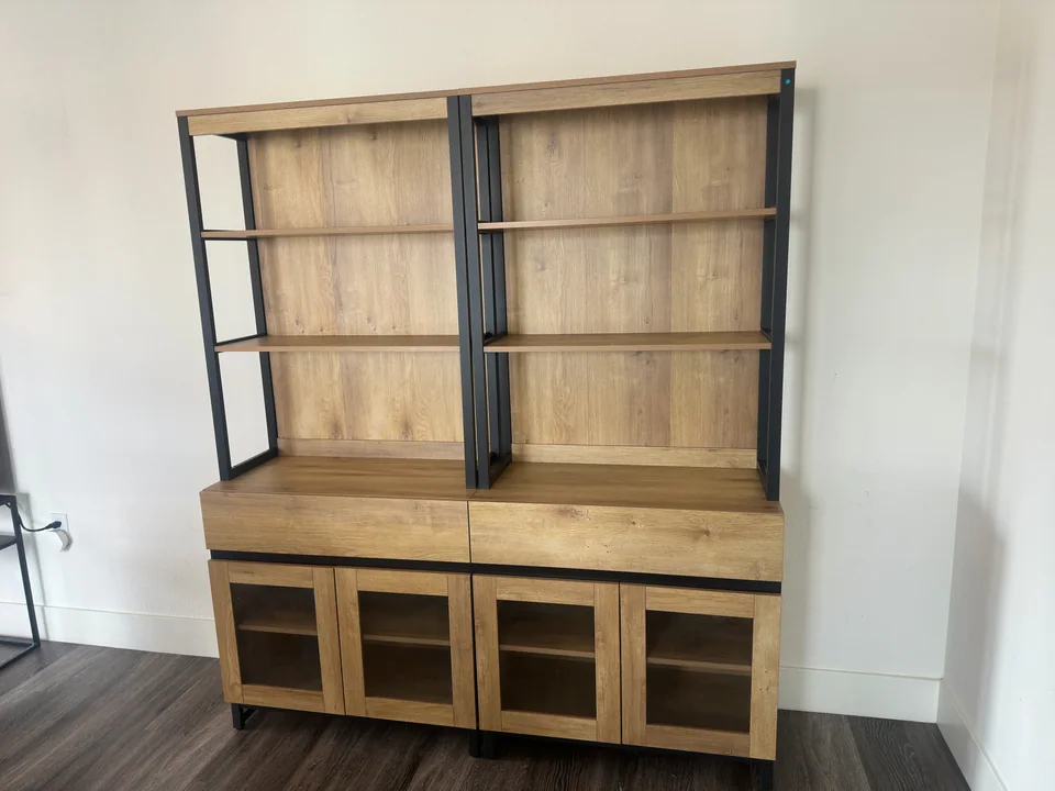 Two matching wood storage units with open shelves and glass-front lower cabinets