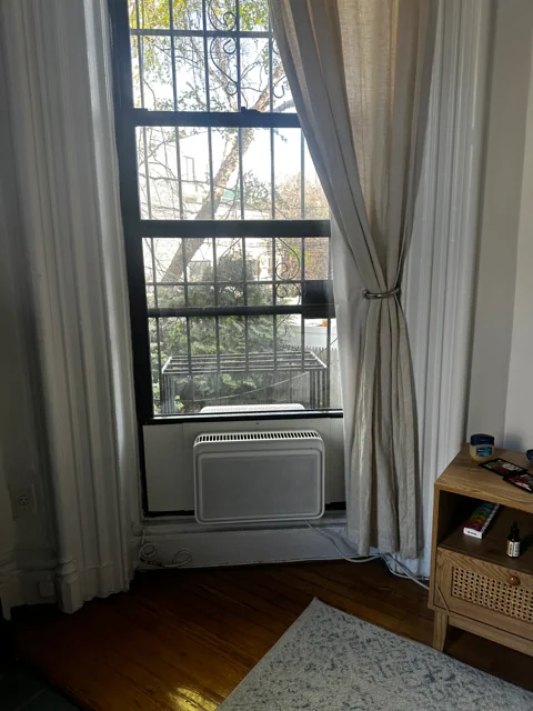 Window air conditioner between light curtains